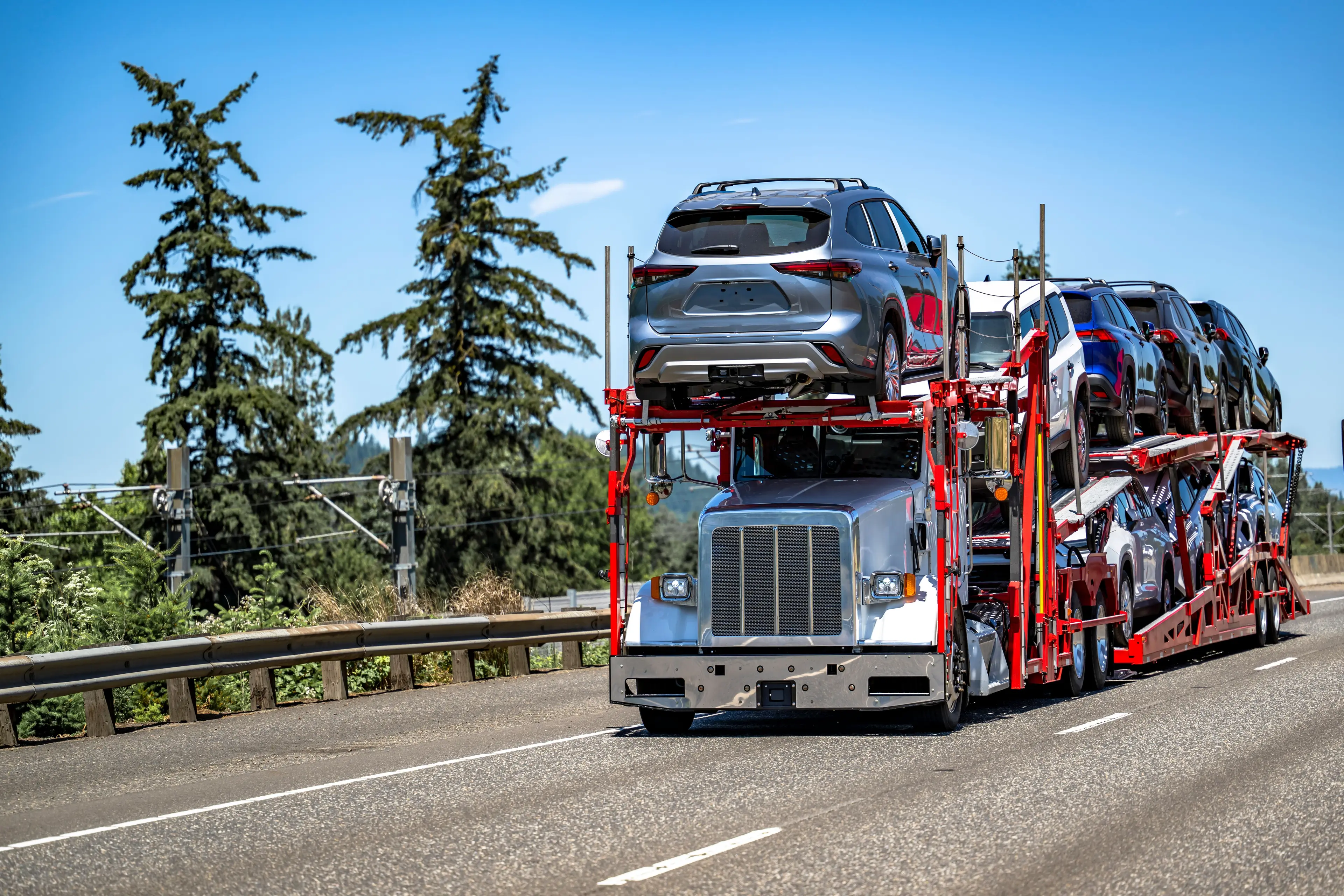 Late-model American-style car carrier transporting multiple vehicles on the highway